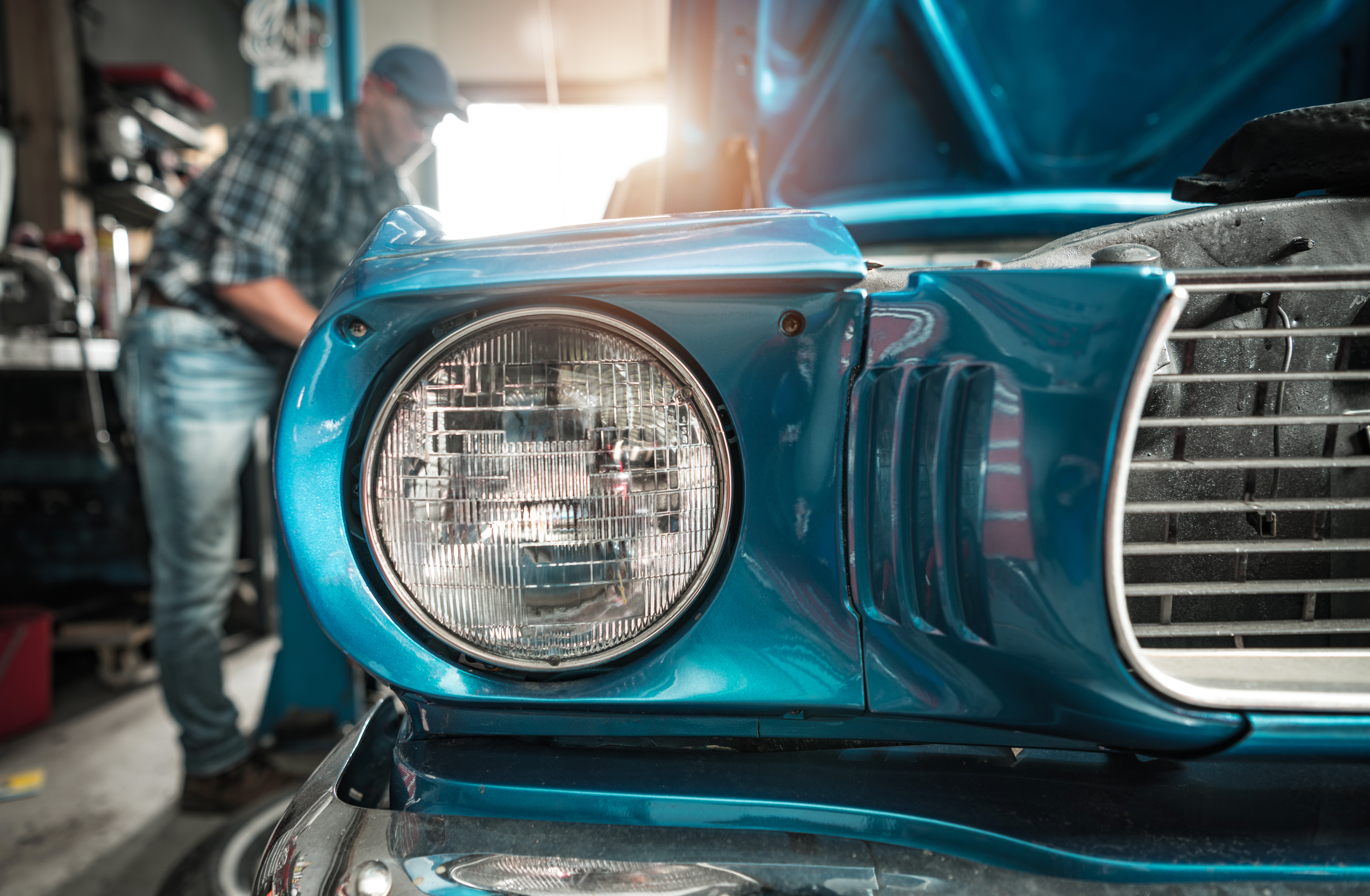 Classic Cars Restoration Worker Next to His Restored Vehicle. Retro Collectibles Theme.